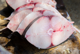 King mackerel fish steaks displayed on a surface. thumbnail