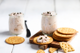 Smoked fish dip in jar next to crackers on top of small cutting board with blurred background thumbnail