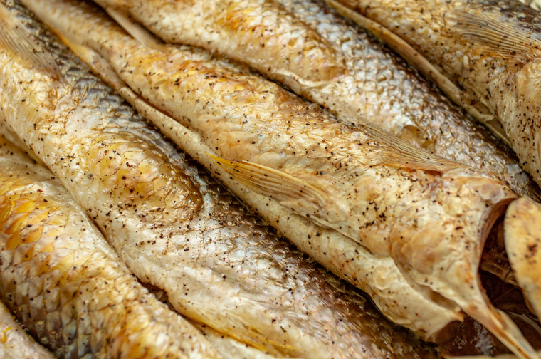 Close-up of several smoked mullets underside